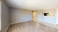 Located at 2009 Cedar Heights Dr in Jonesboro, Arkansas, this single-story home offers three bedrooms and three bathrooms across a well-organized floor plan. The living room is a bright, open space featuring light wood-look flooring, neutral gray walls, crisp white baseboards, and a textured ceiling that adds subtle character. Natural light filters in through blinded windows, creating a welcoming atmosphere throughout. The galley-style kitchen is efficiently laid out with white cabinetry, marble-patterned countertops, white tile flooring, and black appliances including a refrigerator and electric range, providing a clean, functional workspace. The bedrooms are comfortably sized, with the spacious primary bedroom offering ample room for furnishings. Several bedrooms feature vertical shiplap-style wall paneling, wood-look flooring, and windows that bring in natural light. The three bathrooms are consistently finished with tub-shower combinations surrounded by large-format marble-look tile and brushed nickel fixtures, offering a cohesive, clean aesthetic. The overall design of the home is straightforward and functional, with consistent neutral tones and updated finishes that create a move-in-ready environment suitable for a variety of lifestyles.