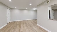 Located at 1229 Pericles Pl in Whitehall, PA, this 1-bedroom, 1-bathroom unit offers a thoughtfully designed single-floor layout with clean, modern finishes throughout. The open-concept living and kitchen area is anchored by light wood-tone luxury flooring, neutral gray walls, and recessed lighting, creating a bright and airy atmosphere. A pass-through window connects the kitchen to the living space, enhancing the open feel. The kitchen is well-equipped with white shaker cabinetry, granite-style countertops, stainless steel appliances including a range, microwave, and dishwasher, and a window above the sink that brings in natural light. The living area provides generous room for furnishings and features a window with blinds that invites additional natural light. The spacious primary bedroom is finished with plush carpeting, a ceiling fan, and dual closets, offering ample storage. A dedicated bathroom features large-format tile flooring, a full soaking tub with a tiled surround, a curved shower rod, and a vanity with granite-style countertops. The unit's consistent neutral palette and modern upgrades provide a clean, move-in-ready environment throughout.