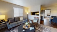 This single-story residence offers a thoughtfully designed layout that balances comfort and functionality throughout its interconnected living spaces. The living room serves as the heart of the home, featuring warm neutral walls, wood-style flooring, and a large window fitted with horizontal blinds that allow natural light to filter in. A sliding glass door provides additional brightness and outdoor access. A pass-through opening connects the living area to the kitchen, enhancing the open feel between spaces.

The galley-style kitchen is efficiently organized, featuring gray cabinetry with brushed hardware, light countertops, a stainless steel sink, and black appliances including a range and refrigerator. Adjacent to the living area, the dining room accommodates a full-sized table and is outfitted with a ceiling fan with lighting overhead and rich wood-tone flooring underfoot.

The bedroom offers a calm retreat with carpet flooring, a large window, and a sliding closet. The bathroom features gray vanity cabinetry, light countertops, a single-basin sink, and a mirror with overhead lighting, complemented by wood-style flooring. Throughout the residence, a consistent neutral color scheme and modern finishes create a cohesive and inviting ambiance.