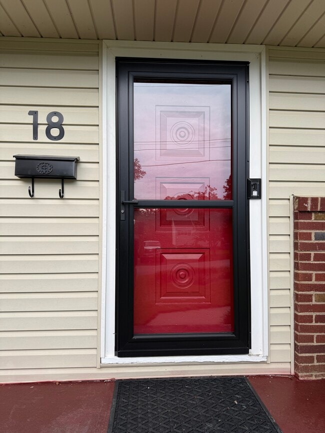 Red Solid Metal Mid Century Modern Entry Door has Heavy Duty Storm Door to provide extra insulation - 18 Waters Ave