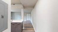 This contemporary 780 square foot apartment in Arbor Park of Alexandria offers a thoughtfully designed one-bedroom layout. The heart of the home is an open-concept living and kitchen area, showcasing sleek wood-style flooring that extends throughout the main living spaces. The kitchen boasts modern stainless steel appliances, including a refrigerator, stove, and over-the-range microwave. White cabinetry and a contrasting blue-gray island create a fresh, clean aesthetic.

The spacious 180 square foot bedroom features plush carpeting and is illuminated by large windows, allowing ample natural light. A ceiling fan adds both style and functionality. The bathroom has been updated with neutral tile surrounds and a modern vanity.

One of the apartment's highlights is the private balcony, accessible through sliding glass doors in the living area. This outdoor space offers a perfect spot for relaxation and al fresco dining. Throughout the apartment, recessed lighting and a neutral color palette contribute to a bright, airy ambiance.

Additional features include a hallway for easy navigation between rooms and a closet for storage. The overall design of this apartment combines functionality with modern aesthetics, creating an inviting living space in a prime Alexandria location.