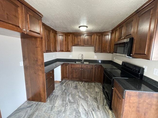 Spacious 6-Bedroom Magna Home with Fenced Yard - Spacious 6-Bedroom Magna Home with Fenced Yard