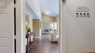 Located in Orlando, FL, this well-appointed 2-bedroom, 2-bathroom residence offers a thoughtfully designed single-floor layout with standout architectural details throughout. Soaring vaulted ceilings in the main living areas create an open, airy atmosphere, while durable wood-style flooring flows seamlessly through the entryway, living room, dining room, and kitchen. The living room is bright and inviting, featuring a ceiling fan, a sliding glass door that opens to a private balcony overlooking a pool, and views of lush palm trees. The kitchen features white cabinetry, dark granite-style countertops, and a pass-through opening that connects directly to the dining area, promoting an open and social layout. The primary bedroom offers vaulted ceilings, a ceiling fan, plush carpeting, a large window for natural light, and a spacious walk-in closet with dual wire shelving. The primary bathroom is equipped with white cabinetry, dark countertops, a large mirror, and a glass-enclosed walk-in shower. The second bedroom is comfortably sized with soft carpeting and additional closet space. A dedicated laundry area houses a full-size washer and dryer. With three closets total and a functional hallway connecting all rooms, this residence balances comfort, practicality, and style in a desirable Orlando location.