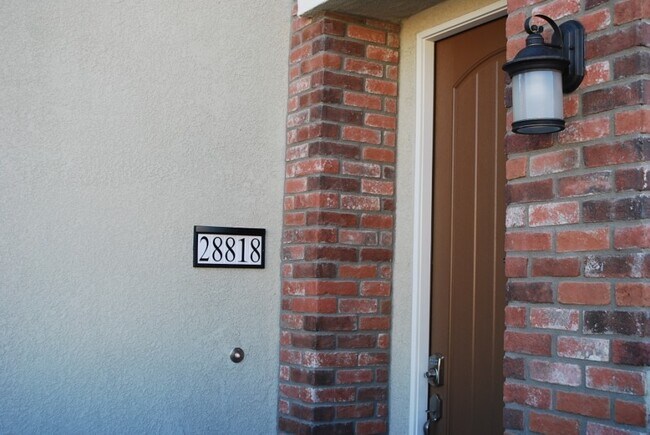Brick-trimmed entry - 28818 Calle De La Paz Dr