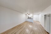 Located at 6351 Country Club Dr in Rohnert Park, CA, this single-floor 1-bedroom, 1-bathroom residence offers a thoughtfully organized layout with clean, modern finishes. The open-concept living and dining area is bright and airy, featuring light-toned luxury vinyl plank flooring, crisp white walls, and a ceiling fan with light fixture. A front-facing window allows natural light to fill the space, creating a welcoming ambiance. The kitchen is efficiently designed with white shaker-style cabinetry, dark countertops, and a full suite of stainless steel appliances including a gas range, microwave, and refrigerator. A pass-through counter connects the kitchen to the living area, enhancing the open feel. The bedroom is comfortably sized, finished with plush carpeting, and features mirrored sliding closet doors that reflect light throughout the room. A window with vertical blinds overlooks the outdoors, adding a sense of connection to the surroundings. The bathroom is outfitted with a white vanity, dark countertop, a large mirror, elegant gold-toned light fixtures, and a shower-tub combination. Additional features include a pantry, hallway, and two closets for ample storage throughout the unit.
