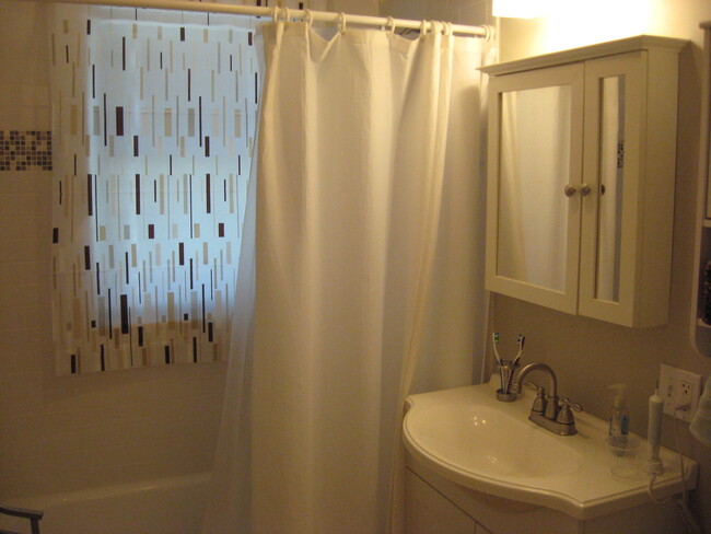 Bathroom with new tile and recently refinished hardwood floors. - 149 Willow Street