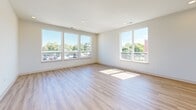 Located at 833 W Main St in Carmel, Indiana, this 2-bedroom, 2-bathroom residence offers a thoughtfully designed single-floor layout with a clean, contemporary aesthetic throughout. Light-toned hardwood-style flooring flows seamlessly across the entire space, complementing the neutral, bright walls that create an airy and welcoming atmosphere.

The open-concept kitchen and living area serves as the heart of the home. The kitchen is well-appointed with white shaker cabinetry, marble-look quartz countertops, a full stainless steel appliance suite including a range, microwave, dishwasher, and refrigerator, and a large central island with an undermount sink and pendant lighting above — ideal for both daily use and entertaining.

The spacious primary bedroom benefits from multiple windows that invite abundant natural light and outdoor views, along with a ceiling fan for added comfort. It is complemented by a generous walk-in closet with built-in shelving. The second bedroom also features large windows with exterior views and warm natural light. One bedroom includes built-in shelving, adding functional storage.

Both bathrooms are finished in a clean, classic style, with one featuring a full tub-shower combination with tiled surround and chrome fixtures. A dedicated in-unit laundry room houses a full-size Whirlpool washer and dryer with overhead wire shelving for additional storage convenience.