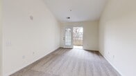 This 690 square foot apartment in Greensboro, NC offers a thoughtful layout maximizing space and functionality. The open-concept design seamlessly integrates the kitchen and living area, creating a sense of spaciousness. The modern kitchen boasts honey-toned cabinetry, granite countertops, and black appliances, including a built-in microwave.

The single bedroom, measuring 160 square feet, features plush carpeting and a ceiling fan for comfort. Large windows throughout the apartment allow for ample natural light, enhancing the airy feel. A glass door in the living area leads to a private balcony, perfect for enjoying fresh air or morning coffee.

The bathroom showcases elegant tile flooring and a wooden vanity with a granite countertop. A dedicated laundry area with in-unit washer and dryer hookups adds convenience. The apartment also includes a hallway and closet space for storage.

Neutral wall colors and carpeting in the main living areas provide a blank canvas for personal decor. The overall design prioritizes functionality and comfort, making efficient use of the available space. This apartment is well-suited for single professionals or couples seeking a modern, low-maintenance living space in a convenient Greensboro location.