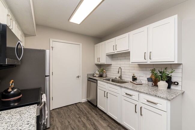 Kitchen with granite counters and modern cabinetry - The Wesley Apartment Homes