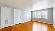 Located at 4309 Chamberlayne Ave in Richmond, Virginia, this single-floor, three-bedroom home offers a practical and cohesive layout designed for comfortable everyday living. Warm-toned hardwood floors run throughout the living areas and all three bedrooms, lending a consistent and inviting character to the space.

The living room serves as the welcoming heart of the home, featuring a six-panel front entry door, light gray walls, and a double window that allows natural light to fill the room. The open, uncluttered design provides a versatile area for various furniture arrangements.

Each of the three bedrooms continues the hardwood flooring and neutral gray palette. The primary bedroom is the most spacious of the three and includes a built-in closet with shelving and hanging rods. The additional bedrooms each offer windows that bring in natural light, with one featuring a view of the surrounding neighborhood. Closet storage is available in multiple bedrooms, maximizing functionality.

The kitchen is equipped with warm wood cabinetry, a stainless steel refrigerator, light countertops, and wood-look vinyl plank flooring, giving it a clean and functional feel. A hallway connects the main living areas and bedrooms, providing a logical flow throughout the home. The overall aesthetic is clean, neutral, and move-in ready.