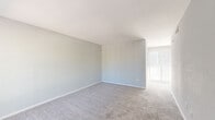 Located at 1515 Wilson Rd in Conroe, Texas, this single-story, 3-bedroom, 1-bathroom home offers a functional and straightforward layout across one floor. The living room is open and bright, featuring soft carpet flooring, neutral light gray walls, and vertical blinds that allow natural light to filter in — creating a clean, airy atmosphere. The galley-style kitchen is efficiently designed with white cabinetry, light stone countertops, a stainless steel sink, and wood-look vinyl flooring. It is equipped with black appliances, including a refrigerator, electric range, and dishwasher, alongside a window with vertical blinds that brings in additional natural light. Each of the three bedrooms features plush carpet flooring and neutral gray walls, lending a consistent and calm aesthetic throughout. The primary bedroom includes a closet for added storage. One bedroom features a ceiling fan with a light fixture, while another includes a dedicated closet. The shared full bathroom is finished with large-format gray stone-look tile surrounding a white soaking tub, offering a polished, updated look. Overall, the home presents a clean, move-in-ready interior with a cohesive neutral palette throughout.