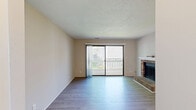 Located in Charlotte, NC, this 2-bedroom, 1-bathroom single-floor residence offers a well-organized layout designed for comfortable everyday living. The living room serves as the heart of the home, featuring wood-look laminate flooring, a textured ceiling, and a classic brick fireplace with a white mantel. Sliding glass doors flood the space with natural light and open directly onto a private balcony, extending the living area outdoors.

The kitchen is thoughtfully updated with white shaker-style cabinetry, dark countertops, a tile backsplash, and a full suite of stainless steel appliances. A peninsula with an extended counter provides additional prep space and casual seating, while a window keeps the area bright and airy. The kitchen flows seamlessly into a dining and entry area finished with the same laminate flooring.

Both bedrooms are carpeted and generously proportioned, with large windows that bring in ample natural light. The spacious primary bedroom offers a walk-in closet, while the second bedroom includes its own closet with hanging storage. The full bathroom connects conveniently to the hallway, serving both bedrooms efficiently. Neutral tones throughout the home create a clean, versatile backdrop ready for personalization.