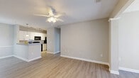 Located at 532 Varnson Ln in Greer, SC, this well-appointed 2-bedroom, 2-bathroom single-story home offers a thoughtfully designed open-concept layout. Light-toned luxury vinyl plank flooring flows throughout the main living areas, complemented by neutral gray walls and crisp white trim that create a clean, modern aesthetic. The living room features a ceiling fan and connects seamlessly to a dedicated dining area illuminated by a stylish pendant chandelier. The kitchen is equipped with white cabinetry, granite countertops, a breakfast bar peninsula, and black appliances, including a refrigerator and microwave. A second dining or living area provides additional flexible space. Both bedrooms are carpeted for comfort, with ceiling fans and windows that allow ample natural light. The primary bedroom is generously sized with access to closet storage. The bathrooms are finished with tile-style flooring, vanity cabinetry with brushed nickel hardware, and a tub-shower combination. Five closets throughout the home provide substantial storage. A dedicated laundry room houses a full-size washer and dryer. The layout is practical and efficient, making excellent use of its well-proportioned single-floor footprint.