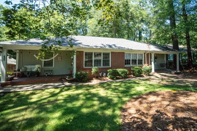 Front of property showing front porch and shaded yard. - 488 Montgomery Ferry Rd NE
