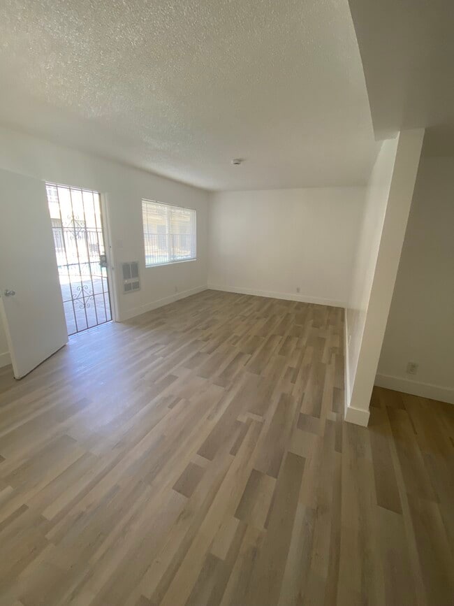 Living Room. New LVT flooring - Sunshine Apartments