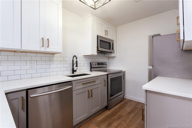 White quartz counters and grey shaker cabinets - 188 Flax Hill Rd