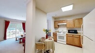 Located at 805 School St in Rahway, NJ, this single-floor residence offers a thoughtfully arranged layout with four bedrooms, two bathrooms, a living room, kitchen, balcony, and two closets. The living room is bright and welcoming, featuring soft neutral carpeting, crown molding, and a sliding glass door that opens to the balcony, allowing abundant natural light and outdoor views to flow into the space. The kitchen is efficiently designed with warm wood cabinetry, a gas range, microwave, and a skylight that bathes the room in natural light. A cozy dining area adjoins the kitchen, providing a convenient space for everyday meals. The spacious primary bedroom benefits from multiple windows with garden views and warm neutral tones, while the additional bedrooms are equally well-lit with windows overlooking greenery. Both bathrooms feature tile flooring, wood vanities, and clean, functional fixtures — one includes a walk-in shower with glass doors and a grab bar for added accessibility. Throughout the residence, a consistent warm, neutral color palette and carpeted floors in living and sleeping areas create a cohesive and comfortable ambiance. The overall design prioritizes practicality and livability, making this a functional and inviting home.