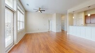 Located at 56 Stamford Street in Asheville, NC, this well-appointed one-bedroom, one-bathroom residence offers a thoughtfully designed single-floor layout. Warm hardwood flooring flows throughout the main living areas, complemented by neutral tones and clean white trim that create a bright, cohesive aesthetic. The open living room is generously sized, featuring a ceiling fan, large windows with natural light, and a glass-paned exterior door that adds an airy feel. The kitchen is a functional highlight, showcasing rich cherry cabinetry, light granite countertops, a tile backsplash, and a full suite of stainless steel appliances including a refrigerator with ice maker, range, built-in microwave, and dishwasher. The bedroom offers comfortable proportions, plush carpet, dual windows, and a ceiling fan, creating a calm and restful retreat. A dedicated walk-in closet provides ample storage with built-in wire shelving. The full bathroom features a granite-topped vanity with cherry cabinetry, a tub-shower combination with tiled surround, and hardwood flooring that ties the space together cohesively. A louvered interior door adds a classic touch to the hallway. This residence combines practical design with quality finishes throughout.