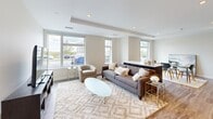 This well-designed one-bedroom, one-bathroom unit in Saugus, MA offers a thoughtfully planned open-concept layout that maximizes its comfortable footprint. The living room is bright and airy, featuring large windows that flood the space with natural light and provide views of the surrounding area. Wide-plank hardwood-style flooring flows seamlessly throughout, lending warmth and continuity to the space.

The modern kitchen is a standout feature, showcasing a striking two-tone design with dark espresso lower cabinetry and crisp white upper cabinets. A marble-veined quartz countertop and white tile backsplash add an elegant touch, while stainless steel appliances — including a gas range, built-in microwave, dishwasher, and French door refrigerator — complete the space. Recessed lighting and a tray ceiling detail enhance the refined aesthetic.

The bedroom offers a tranquil retreat, highlighted by a tray ceiling, recessed lighting, and a generously sized closet with louvered doors. The full bathroom is clean and contemporary, featuring large-format tile flooring, a wide vanity with ample counter space, and a well-lit mirror. The unit's neutral color palette and modern finishes create a cohesive, move-in-ready atmosphere throughout.