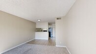 Located at 1628 Bell St in Arcade, California, this 1-bedroom, 1-bathroom unit offers a practical and well-organized single-floor layout designed for comfortable everyday living. The open-concept living and dining area is finished with plush carpet and neutral beige walls, creating a warm and cohesive atmosphere. A large sliding glass door floods the space with natural light and provides direct access to an outdoor area, enhancing the sense of openness throughout.

The kitchen is positioned adjacent to the living area, separated by a white peninsula that doubles as a breakfast bar. It features white cabinetry, laminate countertops, a stainless steel sink, a black electric range, and a full-size black refrigerator, all set on wood-look vinyl flooring that extends through the kitchen and hallway.

The bedroom is generously sized with soft carpeting and receives ample natural light through a large window fitted with vertical blinds. Neutral walls provide a calm, versatile backdrop.

The bathroom includes a full tub-and-shower combination with tile surround, a toilet, and a vanity with a laminate countertop. The space is finished with wood-look tile flooring, maintaining consistency with the rest of the unit. A textured ceiling is present throughout, and HVAC vents are integrated into the walls for climate control.