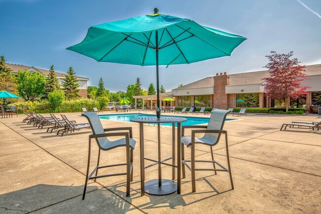 Heated Swimming Pool with lounge furniture at Prentiss Pointe Apartments in Harrison Township, MI - Prentiss Pointe Apartments