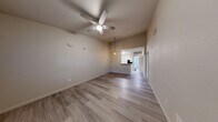 Located at 1325 W Tharpe St in Tallahassee, FL, this single-story, 2-bedroom, 2-bathroom home offers a well-designed layout with light wood-style flooring carried throughout. The open-concept living and dining area is bright and spacious, featuring vaulted ceilings, a ceiling fan, and pendant lighting that creates a warm, airy ambiance. The kitchen is well-appointed with white shaker-style cabinetry, granite-look countertops, a peninsula with bar seating, a deep single-basin sink, and black appliances including an electric range, microwave, and refrigerator. A pantry provides additional storage conveniently adjacent to the kitchen. The primary bedroom is generously sized with high ceilings and direct access to its own bathroom, which includes a vanity with a round mirror and a tub-shower combination with white tile surround. The second bedroom features a sliding mirrored closet door and a window that brings in natural light. Three closets throughout the home offer ample storage. A dedicated laundry area and a bonus room add flexibility to the floor plan. Neutral wall tones and consistent flooring tie the space together, creating a clean and cohesive look throughout.