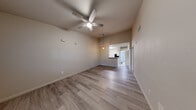 Located at 1325 W Tharpe St in Tallahassee, FL, this single-story, 2-bedroom, 2-bathroom home offers a well-designed layout with light wood-style flooring carried throughout. The open-concept living and dining area is bright and spacious, featuring vaulted ceilings, a ceiling fan, and pendant lighting that creates a warm, airy ambiance. The kitchen is well-appointed with white shaker-style cabinetry, granite-look countertops, a peninsula with bar seating, a deep single-basin sink, and black appliances including an electric range, microwave, and refrigerator. A pantry provides additional storage conveniently adjacent to the kitchen. The primary bedroom is generously sized with high ceilings and direct access to its own bathroom, which includes a vanity with a round mirror and a tub-shower combination with white tile surround. The second bedroom features a sliding mirrored closet door and a window that brings in natural light. Three closets throughout the home offer ample storage. A dedicated laundry area and a bonus room add flexibility to the floor plan. Neutral wall tones and consistent flooring tie the space together, creating a clean and cohesive look throughout.