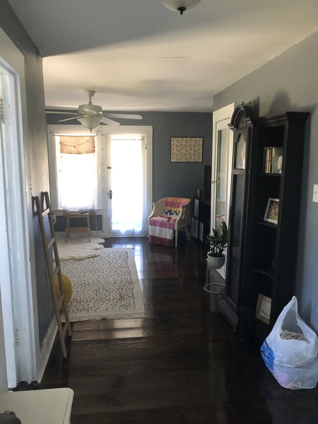 Living room with private balcony (furnishings not included). - 2212 N Massachusetts Ave