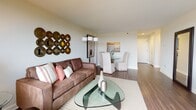Located at 700 Huron Ave in Cambridge, Massachusetts, this single-floor residence offers a thoughtfully designed layout with multiple bedrooms, a full bathroom, an open living and dining area, and a galley-style kitchen. Rich hardwood flooring runs throughout, lending warmth and continuity to the space.

The living room is a welcoming, light-filled area anchored by large windows that frame panoramic views of the Cambridge skyline and surrounding greenery. The open-plan layout connects seamlessly to a dedicated dining area, making it ideal for both everyday living and entertaining.

The galley kitchen is efficiently organized with granite countertops, white cabinetry, a gas range, and ample storage—designed to maximize functionality within its streamlined footprint.

The primary bedroom features mirrored closet doors and a bright window with scenic views, while the second bedroom comfortably accommodates twin beds alongside a window offering the same elevated neighborhood perspective. Both bedrooms feature hardwood floors and neutral tones that create a calm, restful atmosphere.

The bathroom includes a tiled tub-shower combination and a clean, classic vanity with white cabinetry. Throughout the residence, the consistent use of neutral palettes, natural light, and quality finishes creates a cohesive and comfortable living environment.