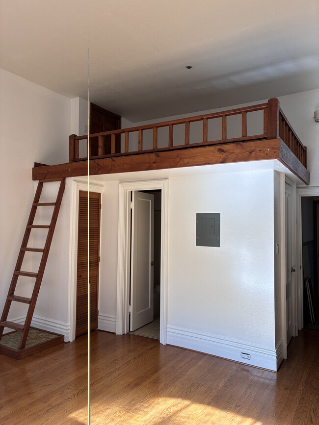 Ladder to loft, storage closet, and door to bathroom - 1516 Third St