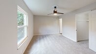 Located at 7700 Gleason Dr in Knoxville, Tennessee, this single-story, 3-bedroom, 2-bathroom home offers a well-organized and functional layout. The galley-style kitchen is a standout feature, showcasing white shaker cabinets, granite-look countertops, stainless steel appliances including an electric range, microwave, and dishwasher, and wood-look flooring that adds warmth to the space. The kitchen connects conveniently to the dining room and laundry area. The living room features soft carpeting and flows naturally toward the patio, allowing for an easy indoor-outdoor connection with views of the surrounding greenery. Each of the three bedrooms is carpeted and equipped with ceiling fans, providing comfort year-round. The spacious primary bedroom includes an expansive built-in closet with bifold doors, offering excellent storage. Secondary bedrooms feature windows that let in natural light. The two bathrooms are outfitted with white tub-shower combinations and matte black fixtures, lending a modern contrast to the clean, bright finishes. With five closets distributed throughout, two hallways, and a dedicated laundry room, this home prioritizes practicality and storage. The textured ceilings and neutral color palette create a consistent, move-in-ready aesthetic throughout.
