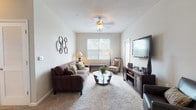 Located at 2100 Shiloh Valley Dr in Kennesaw, Georgia, this single-floor residence offers a thoughtfully designed layout that balances comfort and functionality. The living room features plush wall-to-wall carpeting, a ceiling fan with light fixture, and a bright window that invites natural light into the space, creating a warm and welcoming atmosphere. Adjacent to the living area, the dining space is defined by an elegant pendant light overhead and a pass-through counter connecting seamlessly to the kitchen, enhancing the open-concept flow. The kitchen is outfitted with white shaker-style cabinetry, granite countertops, stainless steel appliances including a dishwasher, and a stainless steel sink — combining style with practicality. The residence includes two bedrooms, each carpeted and featuring neutral-toned walls that lend a calm, restful ambiance. Both bathrooms are finished with granite-topped vanities, white cabinetry, wood-look vinyl flooring, and tub/shower combinations. The consistent use of granite countertops and neutral color palettes throughout ties the space together cohesively, offering a clean and modern aesthetic well-suited for comfortable everyday living.