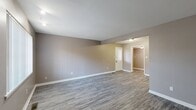 Located at 2908 Glenhaven Dr in Midwest City, Oklahoma, this single-story, 2-bedroom, 2-bathroom home offers a practical and well-appointed layout. The open living room is a welcoming space featuring durable gray vinyl plank flooring, neutral taupe walls, and clean white trim throughout, creating a bright and cohesive aesthetic. Natural light filters in through windows dressed with vertical blinds.

The kitchen is efficiently designed with dark espresso cabinetry, granite-look countertops, an undermount sink, and black appliances. The layout flows naturally, with ample cabinet storage above and below the counters. A dedicated hallway connects the main living areas to the private quarters.

Both bedrooms feature plush carpeting, ceiling fans with integrated lighting, and windows that admit natural light. The spacious primary bedroom offers generous room for furnishings. A dedicated closet provides additional storage.

The two bathrooms are clean and functional. One features a full tub and shower combination with white surround panels, dark overhead cabinetry, and a window for ventilation. The second bathroom includes a standalone walk-in shower with a textured white panel surround and chrome fixtures. Both bathrooms continue the vinyl plank flooring found throughout the main living areas, tying the home together with a consistent, modern finish.