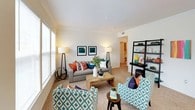 This single-floor residence offers a thoughtfully designed layout that balances comfort and functionality. The open-concept living area is generously sized, featuring plush wall-to-wall carpeting, neutral warm-toned walls, and an abundance of natural light streaming through multiple large windows with blinds. The space flows seamlessly into a dedicated dining area, which is anchored by a pendant light fixture and a skylight that adds an extra layer of brightness, with views of the outdoors through a full-sized window.

The kitchen is equipped with light wood cabinetry, a double-basin sink, a dishwasher, and an electric range, and opens toward the living and dining areas via a pass-through counter. Both bedrooms are well-proportioned with soft carpeting, large windows, and ample room for furnishings. The primary bedroom offers a comfortable retreat with generous natural light and closet access. The second bedroom is equally inviting with its own window and cozy atmosphere.

Two full bathrooms each include a tub-shower combination, vanity with storage cabinetry, and tile flooring. The overall ambiance of the residence is bright, clean, and move-in ready, with a neutral palette that lends itself well to a variety of interior styles.