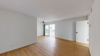 Located in the desirable Westwood neighborhood of Los Angeles, this single-floor unit at 520 Kelton Ave offers a clean, modern aesthetic throughout. Warm-toned wood-style flooring flows seamlessly across all living areas, complementing the bright white walls and creating a cohesive, contemporary feel.

The open living area is spacious and airy, featuring a ceiling fan and sliding glass doors that lead to a private balcony, allowing natural light to pour into the space. The layout connects the living area to a well-appointed galley kitchen, which is equipped with stainless steel appliances including a refrigerator, range, and microwave, along with sleek white cabinetry with matte black hardware and dark stone countertops.

The bedroom is generously sized with a large sliding-door closet offering ample storage, and a bright window fitted with blinds that provides natural light and privacy. An additional room is well-proportioned and adaptable for various uses.

The bathroom features a dark stone vanity countertop, a framed mirror, white cabinetry with matching black hardware, and a separate water closet with a tub-shower combination. Clean white walls throughout maintain a bright, fresh atmosphere. The unit's thoughtful layout and modern finishes make it a functional and attractive space in a prime Los Angeles location.