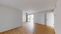 Located in the desirable Westwood neighborhood of Los Angeles, this single-floor unit at 520 Kelton Ave offers a clean, modern aesthetic throughout. Warm-toned wood-style flooring flows seamlessly across all living areas, complementing the bright white walls and creating a cohesive, contemporary feel.

The open living area is spacious and airy, featuring a ceiling fan and sliding glass doors that lead to a private balcony, allowing natural light to pour into the space. The layout connects the living area to a well-appointed galley kitchen, which is equipped with stainless steel appliances including a refrigerator, range, and microwave, along with sleek white cabinetry with matte black hardware and dark stone countertops.

The bedroom is generously sized with a large sliding-door closet offering ample storage, and a bright window fitted with blinds that provides natural light and privacy. An additional room is well-proportioned and adaptable for various uses.

The bathroom features a dark stone vanity countertop, a framed mirror, white cabinetry with matching black hardware, and a separate water closet with a tub-shower combination. Clean white walls throughout maintain a bright, fresh atmosphere. The unit's thoughtful layout and modern finishes make it a functional and attractive space in a prime Los Angeles location.