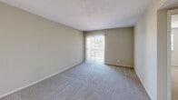 Located at 1309 Carrollton Ave in Metairie, Louisiana, this one-bedroom, one-bathroom unit offers a well-organized single-floor layout designed for comfortable everyday living. The carpeted living area is bright and open, featuring a sliding glass door with vertical blinds that fills the space with natural light and provides access to a private patio. The galley-style kitchen is efficiently designed with warm wood cabinetry, light countertops, tile flooring, and black appliances including a range, microwave, dishwasher, and refrigerator. A pendant light illuminates the adjoining dining area, which benefits from a window with blinds. The generously sized primary bedroom features plush carpet, a ceiling fan with light fixture, and a window that allows natural light. Additional rooms include a closeted hallway area and dedicated laundry space. Three closets throughout the unit provide ample storage. The bathroom is well-appointed with a tub/shower combination, a wood-accented vanity, and tile flooring. Textured ceilings are found throughout, contributing to the unit's classic character. The layout is practical and cohesive, making efficient use of every area within the space.