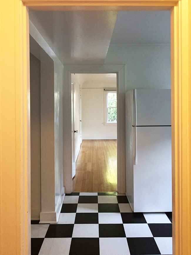view from hallway through kitchen into living room. - 2056 NW Overton St