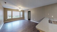 Located at 100 Laurel Pointe Cir in Salisbury, NC, this single-floor residence offers a practical and comfortable layout designed for everyday living. The main living area features durable wood-look flooring and is brightened by natural light streaming through windows fitted with blinds. A ceiling fan overhead adds both style and function to the space. The kitchen is well-equipped with white cabinetry, a black appliance suite including a refrigerator and electric range, light countertops, and a pantry closet for added storage. An adjacent dining or flex area with matching flooring connects seamlessly to the rest of the home. The bedrooms are carpeted in neutral tones and painted in warm gray hues, providing a calm and restful atmosphere. One bedroom features a pass-through to a connected bathroom, enhancing convenience. The bathrooms include tub-shower combinations, wood-look flooring, vanities with mirrors, and one bathroom offers additional built-in shelving for storage. Throughout the home, consistent neutral gray wall tones and white trim create a cohesive, clean aesthetic. The floor plan, visible in the dollhouse view, reveals an efficient and well-organized single-level layout suitable for a variety of living arrangements.