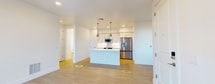 This contemporary 810 square foot apartment in Avondale, Arizona offers a thoughtful layout maximizing space and functionality. The open-concept design seamlessly integrates the kitchen, living, and dining areas, creating an airy atmosphere enhanced by ample natural light from large windows and sliding balcony doors.

The kitchen is a standout feature, boasting sleek white cabinetry, stainless steel appliances, and a generous island with a built-in sink, perfect for food preparation or casual dining. Pendant lighting adds a touch of modern elegance.

The bedroom, measuring 140 square feet, provides a cozy retreat with a large window offering outdoor views. The bathroom showcases a modern vanity with ample storage, a glass-enclosed shower, and stylish fixtures.

Practicality meets comfort with an in-unit laundry area, complete with a high-efficiency washer. Throughout the apartment, wood-look flooring lends warmth and durability, while recessed lighting and ceiling fans ensure a well-lit, comfortable environment.

The property's single floor layout and thoughtful design make it an ideal space for singles or couples seeking a contemporary, low-maintenance living solution in the heart of Avondale.