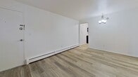 This 490 square foot apartment in Louisville, KY offers a well-designed living space with two bedrooms and one bathroom. The unit showcases a modern aesthetic with newly installed wood-look flooring throughout, creating a cohesive and contemporary appearance. The primary bedroom, measuring 130 square feet, provides ample space for a comfortable retreat. The second bedroom, while smaller, still offers functionality for various uses.

The living area is bright and open, featuring white walls that enhance the sense of space and natural light from the windows. The kitchen, though compact, is efficiently designed with white cabinetry, marble-look countertops, and stainless steel appliances, including a sink and stove. The bathroom is clean and functional, with white tiled walls and a standard bathtub-shower combination.

Windows in the bedrooms and living area not only provide natural light but also offer views of the surrounding area. The apartment is equipped with baseboard heating and a window air conditioning unit for year-round comfort. Despite its modest size, the layout maximizes the available space, creating a cozy and practical living environment suitable for individuals or small families.