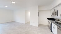 Located in Miami's vibrant 33127 zip code, this single-story, 5-bedroom, 2-bathroom home offers a well-organized layout designed for comfortable living. The interior is finished with light-toned tile flooring throughout, crisp white walls, and clean lines that create a bright and airy atmosphere.

The modern kitchen is a standout feature, equipped with white shaker-style cabinetry, dark granite countertops, and a full suite of stainless steel appliances including a range, microwave, dishwasher, and refrigerator. Recessed lighting and tile flooring complete the sleek, functional space.

Each of the five bedrooms is finished in neutral tones with large windows that invite natural light and views of surrounding greenery. Several bedrooms include built-in closets with sliding or paneled doors, and the primary bedroom offers a generous footprint. The rooms are connected by two hallways, one of which provides convenient access to a bathroom featuring a vanity with white cabinetry and a mirror.

Both bathrooms are appointed with walk-in showers tiled floor-to-ceiling in large-format charcoal slate-style tiles, accented by classic white hexagonal mosaic flooring — delivering a clean, contemporary aesthetic. The home's efficient layout and modern finishes make it a practical and well-appointed residence in Miami.
