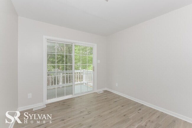 Building Photo - This spacious 4BR 2.5BA home features an o...