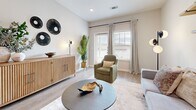 Located at 1650 Harris Hill Rd in San Marcos, TX, this single-story, 2-bedroom, 2-bathroom home offers a thoughtfully designed open-concept layout with modern finishes throughout. Light wood-look flooring flows through the main living areas, complementing the bright, neutral color palette and recessed lighting overhead.

The combined living, dining, and kitchen area forms the heart of the home. The kitchen is outfitted with white shaker cabinetry, granite countertops, a subway tile backsplash, stainless steel appliances, and a central island with bar seating — ideal for both cooking and casual dining. The living room receives ample natural light through large windows and offers a welcoming, open atmosphere.

The primary bedroom is a comfortable retreat with plush carpeting, a ceiling fan, and direct access to a spacious walk-in closet with built-in shelving. The second bedroom also features carpet flooring and a bright window. Both bathrooms include white cabinetry, granite countertops, and wood-look tile flooring. A dedicated office provides a functional workspace, while the separate laundry room and three closets add practical storage. The overall ambiance is clean, modern, and move-in ready.