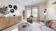 Located at 1650 Harris Hill Rd in San Marcos, TX, this single-story, 2-bedroom, 2-bathroom home offers a thoughtfully designed open-concept layout with modern finishes throughout. Light wood-look flooring flows through the main living areas, complementing the bright, neutral color palette and recessed lighting overhead.

The combined living, dining, and kitchen area forms the heart of the home. The kitchen is outfitted with white shaker cabinetry, granite countertops, a subway tile backsplash, stainless steel appliances, and a central island with bar seating — ideal for both cooking and casual dining. The living room receives ample natural light through large windows and offers a welcoming, open atmosphere.

The primary bedroom is a comfortable retreat with plush carpeting, a ceiling fan, and direct access to a spacious walk-in closet with built-in shelving. The second bedroom also features carpet flooring and a bright window. Both bathrooms include white cabinetry, granite countertops, and wood-look tile flooring. A dedicated office provides a functional workspace, while the separate laundry room and three closets add practical storage. The overall ambiance is clean, modern, and move-in ready.
