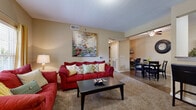 This single-story residence in Kansas City, Kansas, offers a thoughtfully designed layout that balances comfort and functionality throughout its living spaces. The living room serves as the central gathering area, featuring plush carpeting, neutral warm-toned walls, a ceiling fan, and a large window that invites natural light and outdoor views. The open flow connects seamlessly to a dedicated dining area, where hardwood-style flooring continues into the galley-style kitchen. The kitchen is well-equipped with dark espresso cabinetry, granite-style countertops, stainless steel appliances including a range, built-in microwave, dishwasher, and refrigerator — providing ample storage and prep space. A doorway from the kitchen leads directly to an in-unit laundry area, adding everyday convenience. The primary bedroom is generously proportioned with plush carpeting, vaulted-style ceilings, natural light from a window, and dual reach-in closets offering substantial storage. A second bedroom features carpeting and a large window. Both bathrooms are finished with tile flooring, dark wood vanities, granite-style countertops, and full tub-shower combinations, delivering a clean, cohesive aesthetic throughout the home.