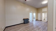Located at 510 E Washington St in Bloomington, Illinois, Unit 108 is a two-bedroom, one-bathroom residence offering a well-designed single-level layout. Light-toned luxury vinyl plank flooring runs throughout the entire unit, providing a clean, cohesive aesthetic that complements the warm neutral wall tones found in every room.

The kitchen is a functional standout, equipped with a full suite of stainless steel appliances including a refrigerator, electric range, built-in microwave, and dishwasher. Rich, dark-stained cabinetry extends to the upper walls, offering abundant storage, while granite-style countertops add a polished finish.

Both bedrooms are comfortably sized, with the primary bedroom offering generous square footage. Tall ceilings amplify the sense of openness, and large windows with blinds allow ample natural light to fill the rooms. The second bedroom also features multiple windows overlooking greenery outdoors. Bedroom closets include sliding double doors for convenient access and storage.

The bathroom is thoughtfully appointed with a tub/shower combination, a curved curtain rod, stainless grab bars for added accessibility, a vanity with granite-style countertop, and a well-placed overhead light. The overall design is clean, modern, and practical, making this unit a comfortable and efficient living space.