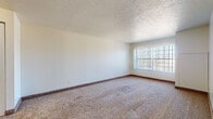 Located at 11560 Somerset Dr in North Royalton, Ohio, this single-floor residence offers a practical and comfortable layout throughout. The living area is generously sized, featuring neutral-toned carpet, textured ceilings, and a large picture window that fills the room with natural light and provides outdoor views. The open flow of the space connects the living area to a hallway leading to the bedrooms and kitchen.

The kitchen is well-appointed with dark gray cabinetry, granite-look countertops, a double sink, and wood-look plank flooring, giving it a clean and modern feel. White appliances, including a refrigerator and range, complement the cabinetry, and overhead lighting ensures a bright workspace.

The bedrooms are carpeted and feature windows with window treatments that allow for natural light. One bedroom includes a walk-in closet, offering ample storage space. The bathroom is tastefully finished with mosaic tile flooring and tub surround, a soaking tub with a handheld showerhead, and dark-toned cabinetry for storage above the toilet.

Throughout the residence, the consistent use of carpet in living and sleeping areas and hard-surface flooring in functional spaces creates a cohesive and practical design. The overall ambiance is clean, bright, and move-in ready.