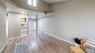 Located in Bremerton, WA, this 2-bedroom, 1-bathroom single-level home offers a thoughtfully designed layout with modern updates throughout. Light-toned luxury vinyl plank flooring runs consistently across the living areas, complementing the neutral warm-gray walls and crisp white trim that give the space a clean, contemporary feel.

The open living area is a standout feature, boasting soaring vaulted ceilings that lend a sense of openness well beyond its physical footprint. High clerestory windows draw in natural light from above, while built-in open shelving adds both character and practicality to the space. A structural column adds an architectural detail that subtly defines the transition between the living and kitchen areas. The kitchen is equipped with white cabinetry, a white range, and a refrigerator.

Both bedrooms feature large windows that frame outdoor greenery, providing ample natural light and a connection to the surroundings. Each room includes its own closet and baseboard heating. The primary bedroom is a comfortable, private retreat. The bathroom is outfitted with a full tub-shower combination with a clean white surround.

A connecting hallway and four closets throughout the home ensure generous storage. The textured ceilings add a classic touch, rounding out this efficiently designed and updated home.