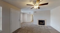 This single-story residence in Jackson, Tennessee, offers a practical and comfortable layout across three bedrooms and two full bathrooms. The living room serves as the heart of the home, featuring plush carpet flooring, a ceiling fan with integrated lighting, and a tile-surround wood-burning fireplace that anchors the space as a functional focal point. Neutral wall tones and a textured ceiling carry throughout the common areas, lending a cohesive, understated aesthetic.

The kitchen has been thoughtfully updated with crisp white cabinetry, light quartz-style countertops, and light wood-look vinyl plank flooring. A full suite of stainless steel GE appliances—including a range, over-the-range microwave, refrigerator, and dishwasher—provides modern convenience, while a double-basin sink completes the workspace.

Each of the three bedrooms features soft carpet, neutral walls, and dedicated closet space with built-in shelving and hanging rods, offering practical storage solutions. The two full bathrooms are finished with light tile flooring, white vanities, and tub-shower combinations, maintaining a clean and functional design throughout. The floor plan flows efficiently, connecting the living, kitchen, and bedroom areas in a straightforward single-level arrangement.